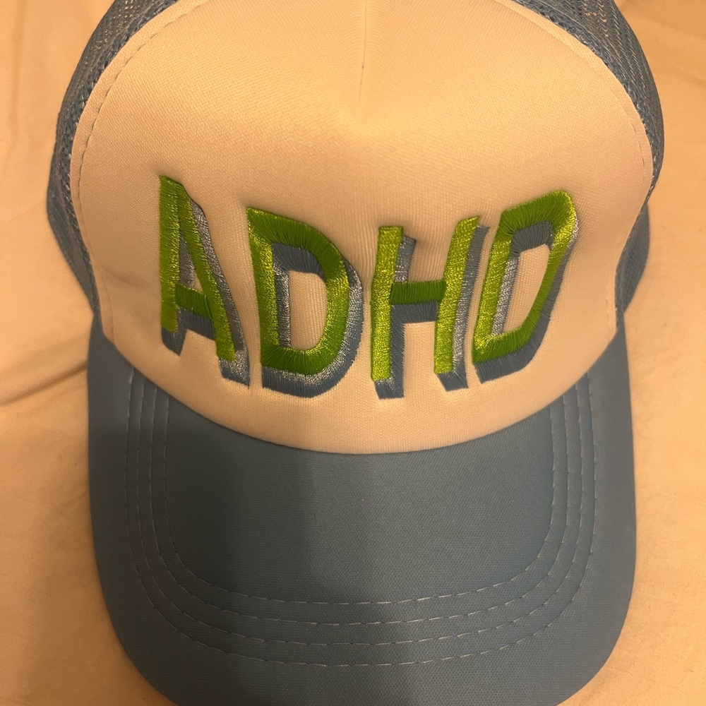 Blue and White Trucker Hat with Green Lettering‎